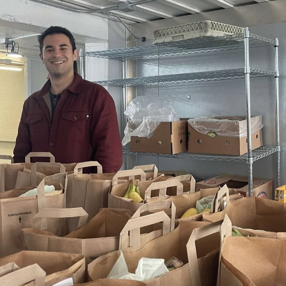 Volunteer with fully loaded BrightSide Produce boxes ready to be distributed to underserved communities in Minneapolis and St. Paul.